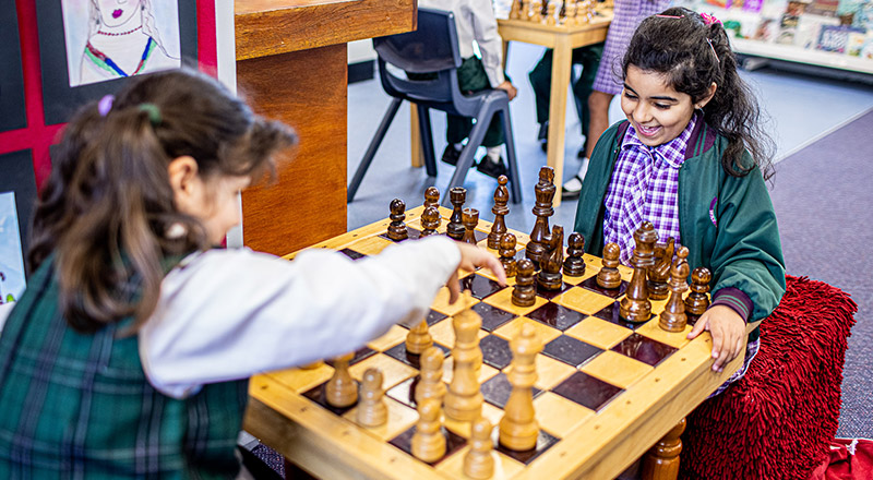 Girls playing chess at Holy Cross Catholic Primary Glenwood