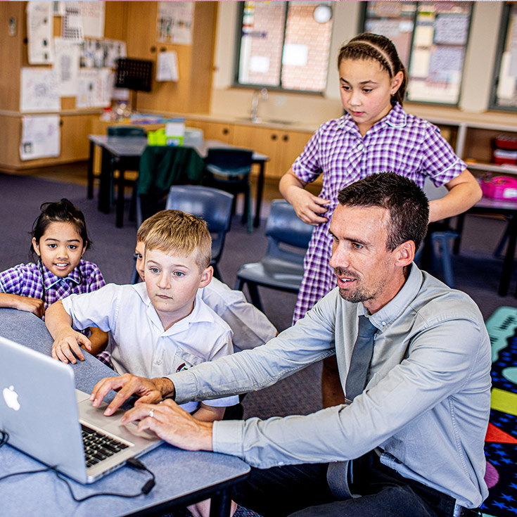 Teacher with students at Holy Cross Catholic Primary Glenwood