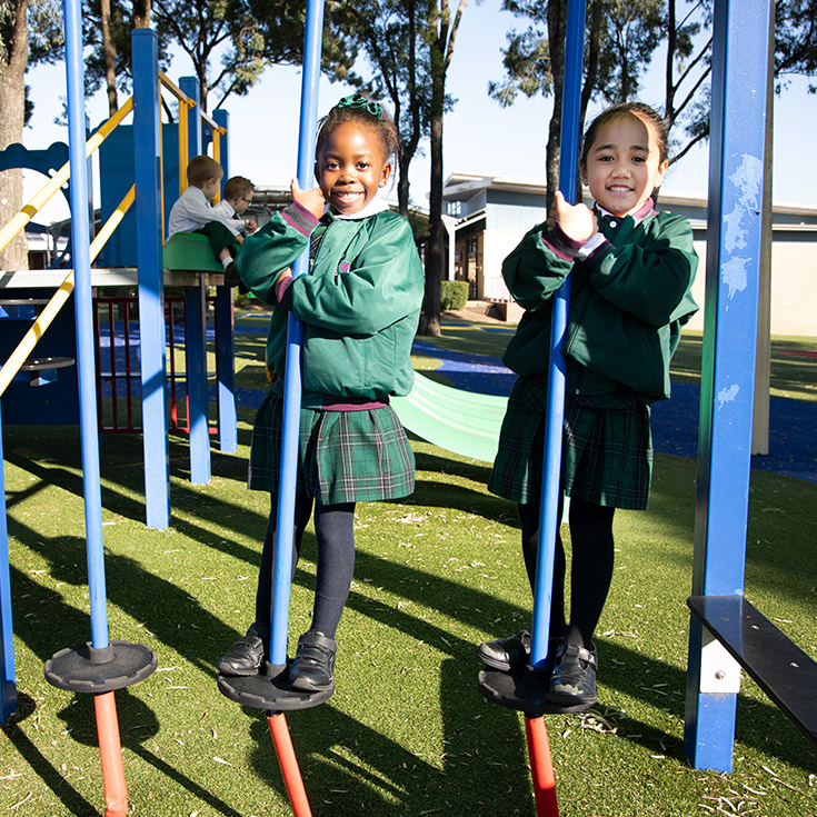 Holy Cross Catholic Primary Glenwood girls on outdoor play equipment