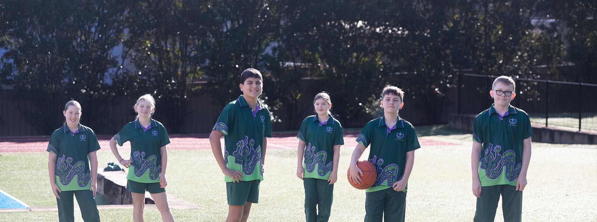 Holy Cross Glenwood Primary Students playing basketball on school sports field